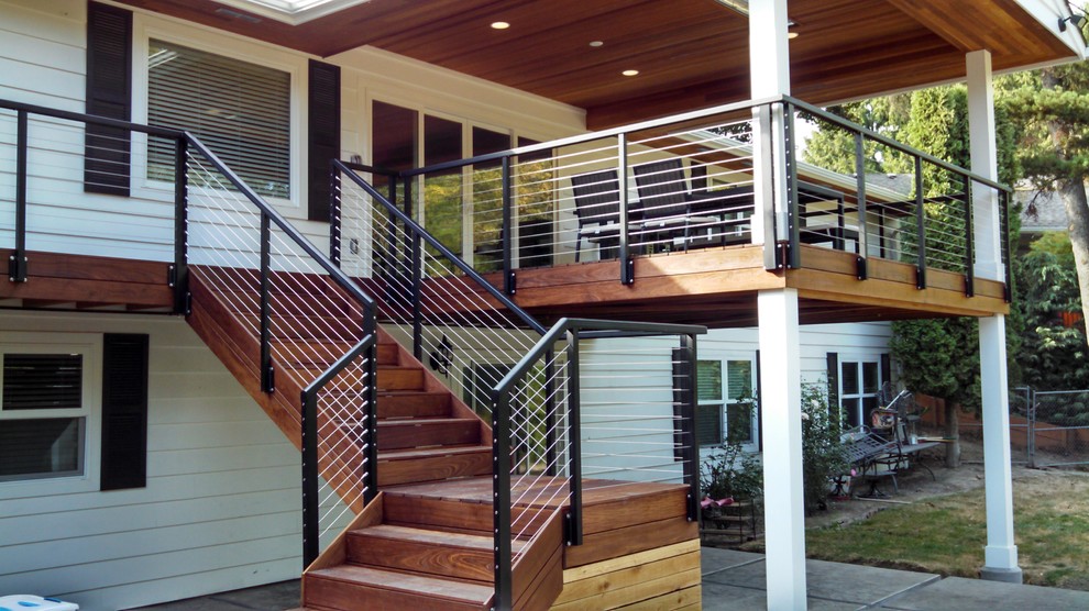 Inspiration for a mid-sized arts and crafts backyard deck in Portland with a roof extension.