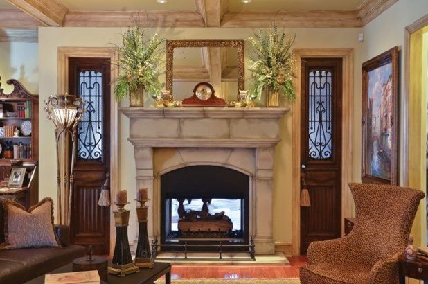 This is an example of a traditional living room in Dallas with a standard fireplace and a stone fireplace surround.