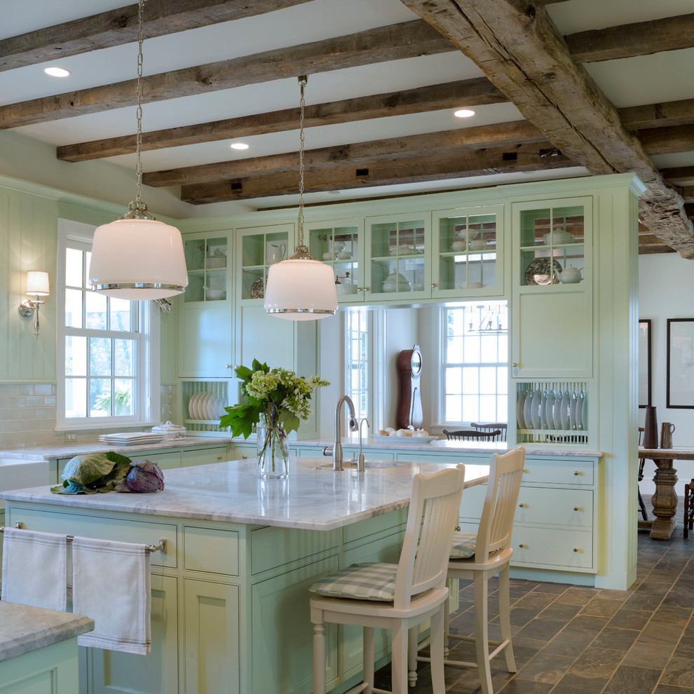 Inspiration for a country u-shaped eat-in kitchen in DC Metro with a farmhouse sink, glass-front cabinets, green cabinets, marble benchtops, beige splashback, subway tile splashback and stainless steel appliances.