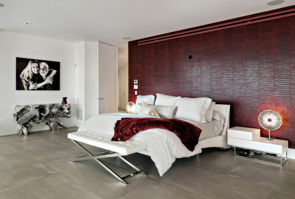 Design ideas for a contemporary master bedroom in Miami with red walls and grey floor.