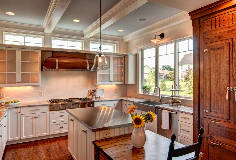 This is an example of a traditional kitchen in Other with a farmhouse sink and stainless steel benchtops.