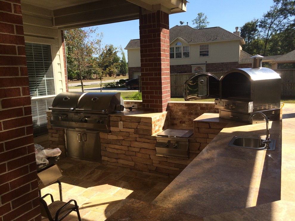 Design ideas for a large transitional backyard patio in Houston with an outdoor kitchen, tile and a pergola.