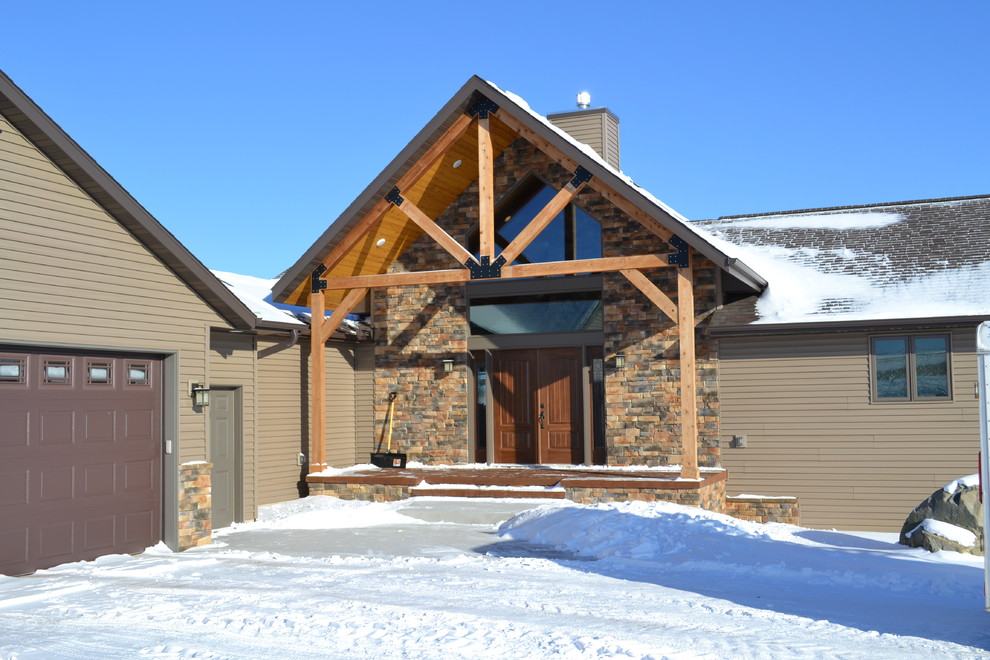 This is an example of a mid-sized country two-storey exterior in Other with mixed siding.