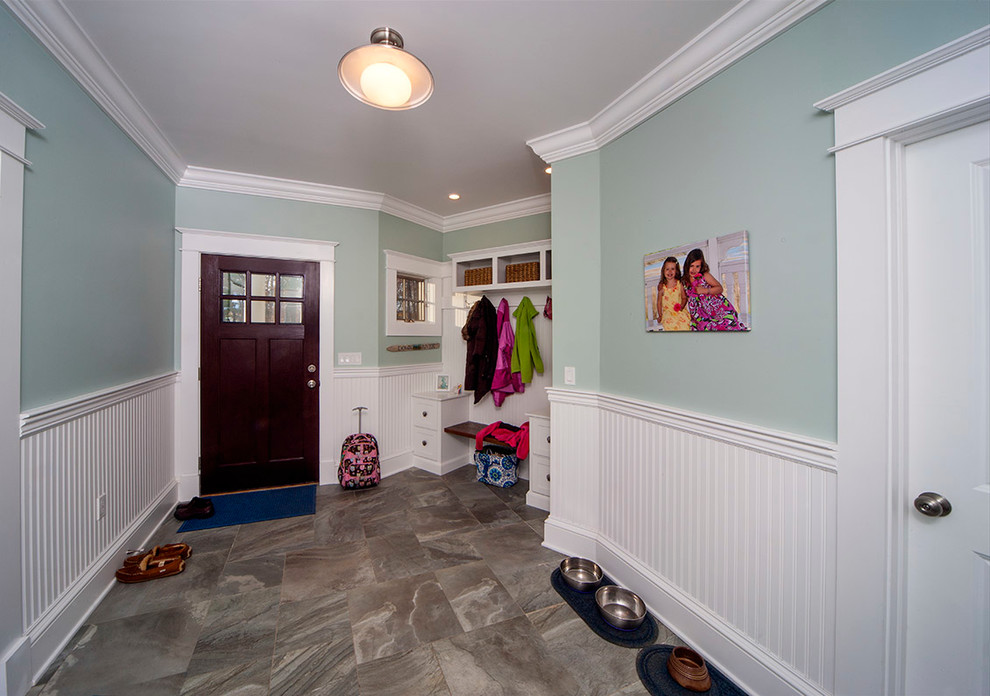 Inspiration for a large traditional mudroom in Boston with blue walls, porcelain floors, a single front door and a dark wood front door.