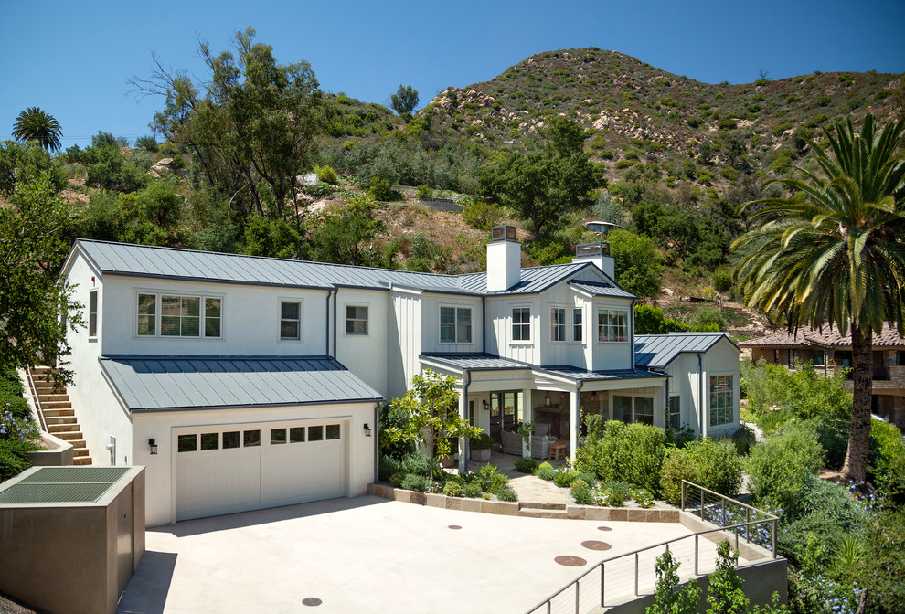 This is an example of a large beach style two-storey white exterior in Santa Barbara with mixed siding.