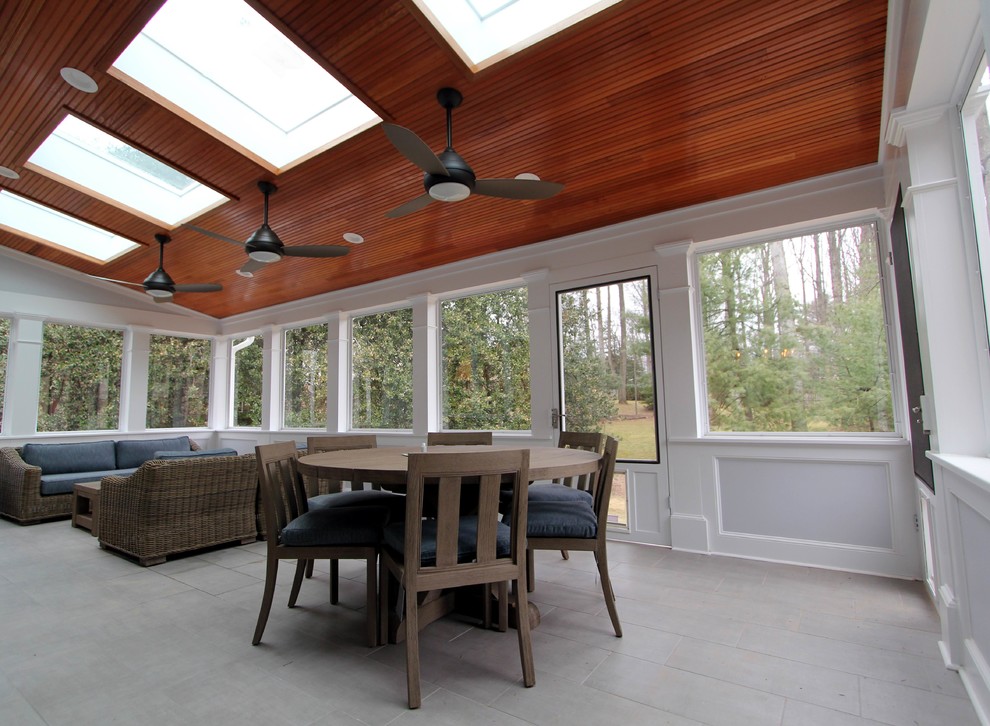 Large transitional backyard screened-in verandah in DC Metro with tile and a roof extension.