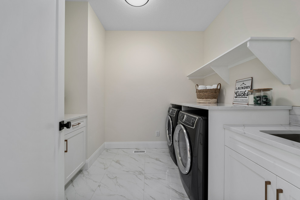 Transitional laundry room photo in Calgary