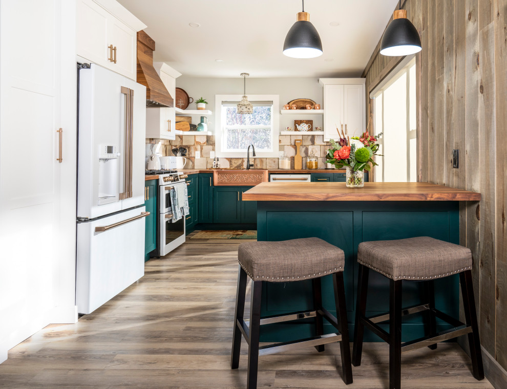 Design ideas for a small country l-shaped kitchen in Other with a farmhouse sink, shaker cabinets, green cabinets, wood benchtops, beige splashback, ceramic splashback, white appliances, medium hardwood floors, with island, brown floor and brown benchtop.