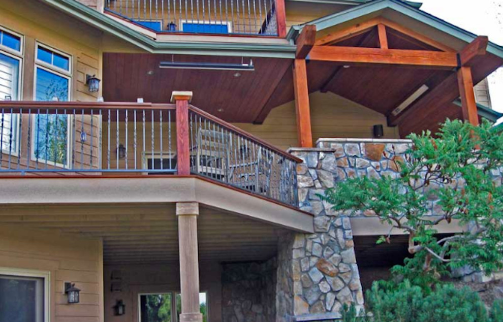 Large mountain style balcony photo in Denver with a roof extension
