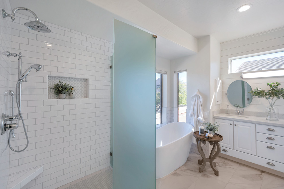 Example of a mid-sized transitional master white tile and subway tile porcelain tile and white floor freestanding bathtub design in Phoenix with a hinged shower door