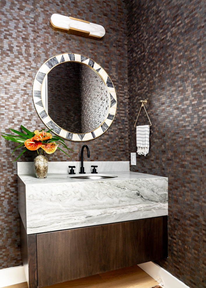 California Modern - Inspiration for a mediterranean light wood floor powder room remodel in Orange County with flat-panel cabinets, dark wood cabinets, multicolored walls, an undermount sink and multicolored countertops