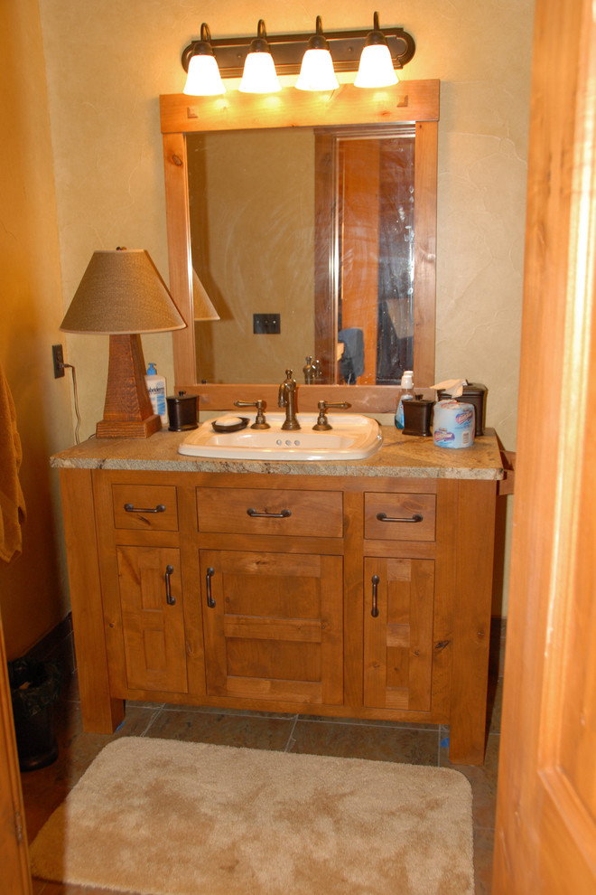 Design ideas for a small country powder room in Portland with shaker cabinets, medium wood cabinets, beige walls, ceramic floors, a drop-in sink, beige floor, multi-coloured benchtops and a built-in vanity.