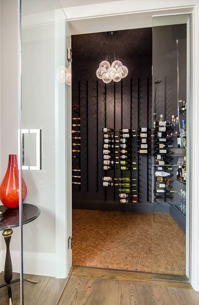 Design ideas for a mid-sized transitional wine cellar in Dallas with cork floors and storage racks.