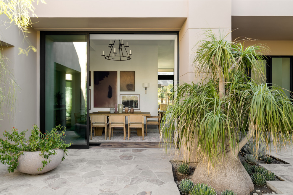 Huge southwest courtyard stone patio photo in Other with a fire pit and no cover
