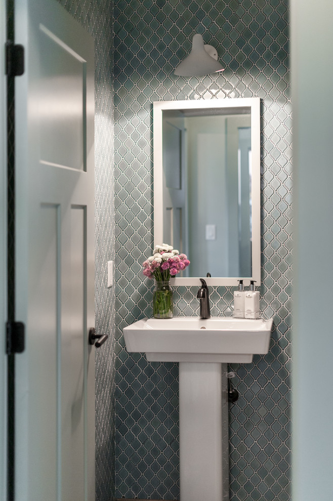 This is an example of a small contemporary powder room in Detroit with blue tile, ceramic tile, a pedestal sink and blue walls.