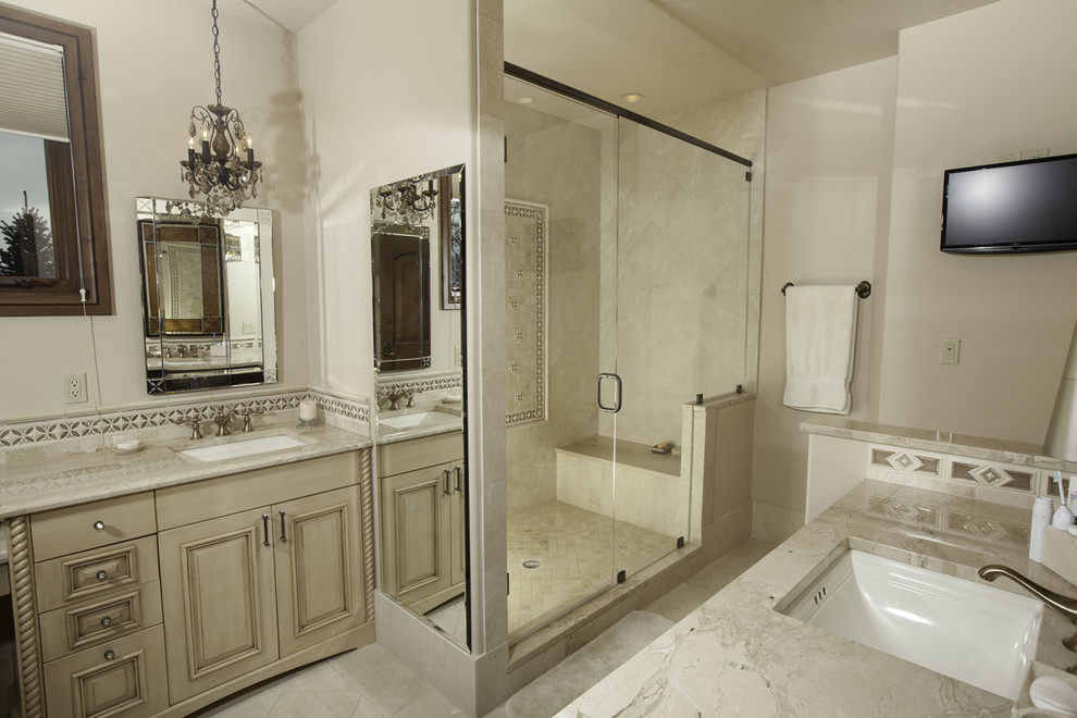 Inspiration for a mid-sized traditional master bathroom in Denver with recessed-panel cabinets, beige cabinets, an alcove shower, beige tile, ceramic tile, beige walls, dark hardwood floors, a drop-in sink and granite benchtops.