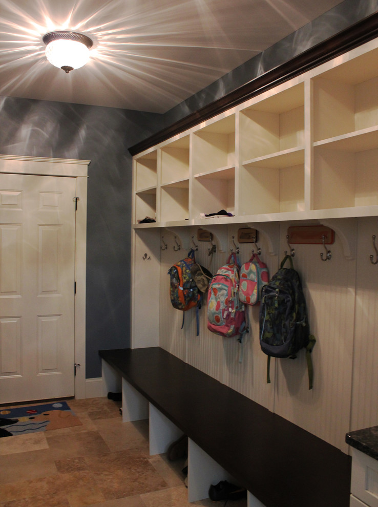 Example of a large transitional travertine floor mudroom design with blue walls
