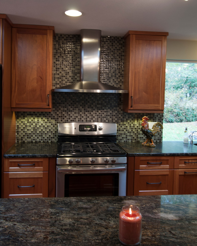 This is an example of a transitional kitchen in Seattle with stainless steel appliances.