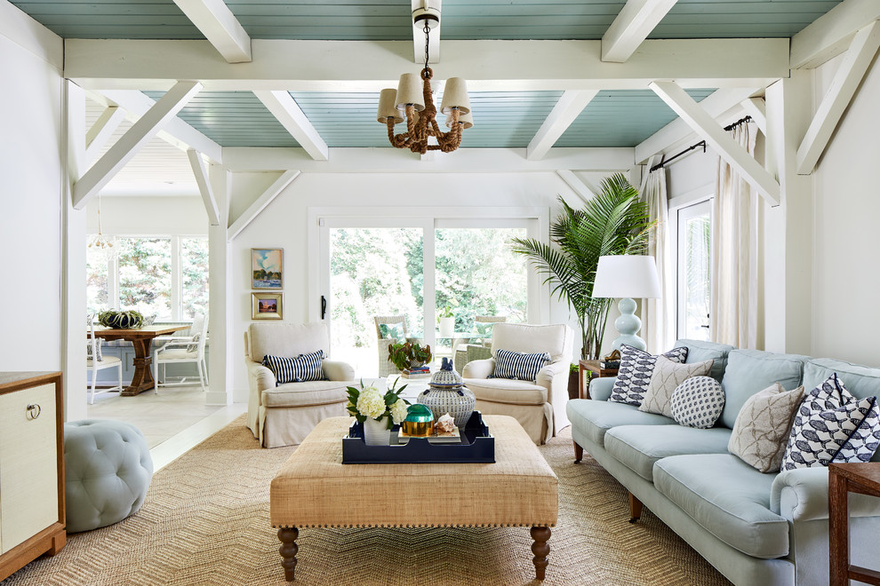 This is an example of a beach style open concept living room in DC Metro with white walls.