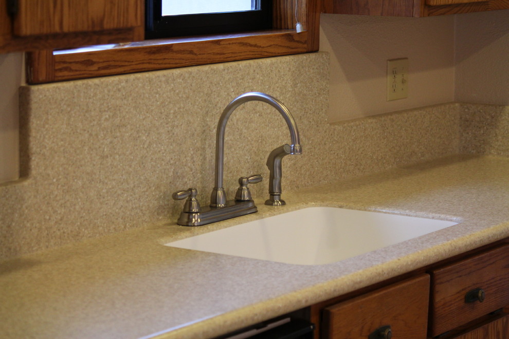 Inspiration for a timeless kitchen remodel with an integrated sink and solid surface countertops