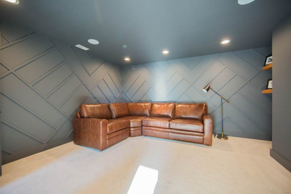 This is an example of a mid-sized contemporary home studio in Indianapolis with black walls, laminate floors, brown floor and panelled walls.