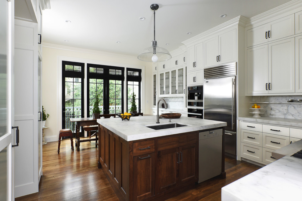 Eat-in kitchen - mid-sized transitional u-shaped dark wood floor and brown floor eat-in kitchen idea in San Francisco with an undermount sink, recessed-panel cabinets, white cabinets, marble countertops, white backsplash, marble backsplash, stainless steel appliances and an island