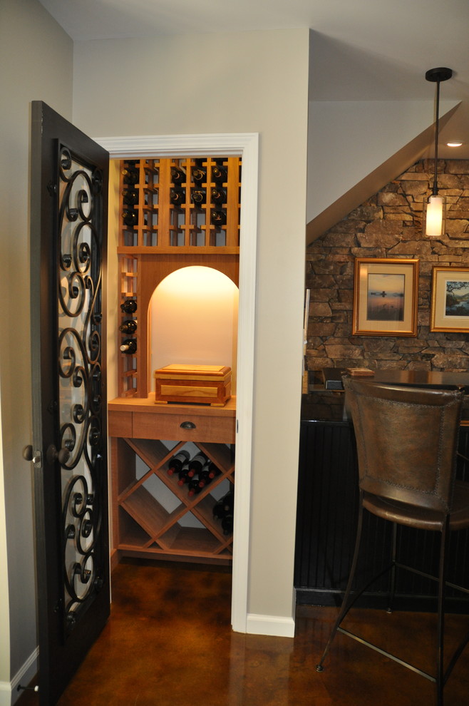 This is an example of a small eclectic wine cellar in Other with display racks.