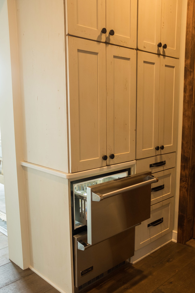 Inspiration for a large transitional galley dark wood floor and brown floor open concept kitchen remodel with a farmhouse sink, shaker cabinets, quartz countertops, brown backsplash, brick backsplash, stainless steel appliances and an island