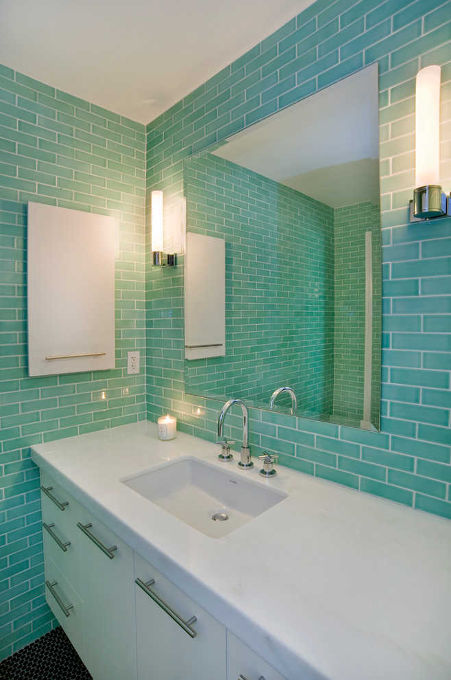 This is an example of a mid-sized kids bathroom in Miami with flat-panel cabinets, white cabinets, tile benchtops, green tile, mosaic tile, green walls and mosaic tile floors.