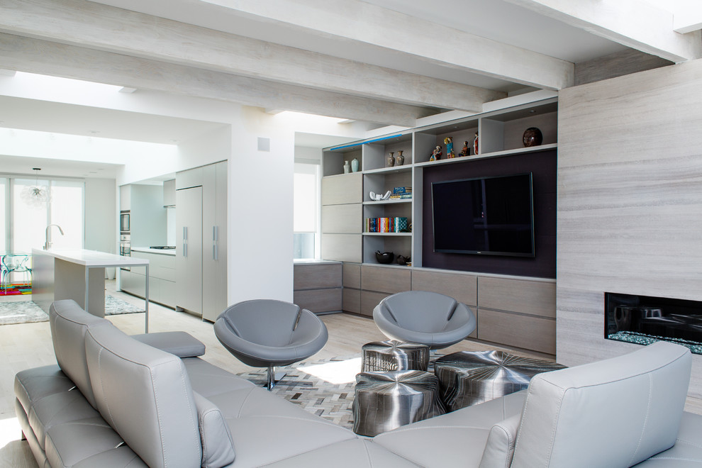 This is an example of a contemporary formal open concept living room in San Francisco with white walls, light hardwood floors, a ribbon fireplace and a wall-mounted tv.