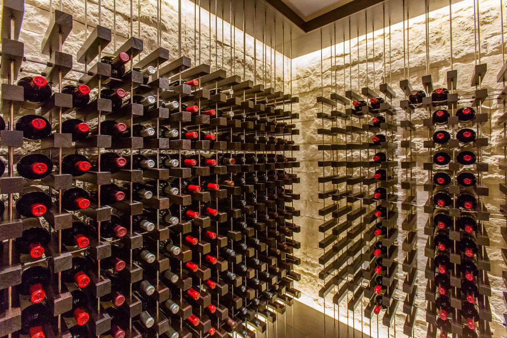 Photo of a mid-sized contemporary wine cellar in Boston with storage racks, travertine floors and grey floor.