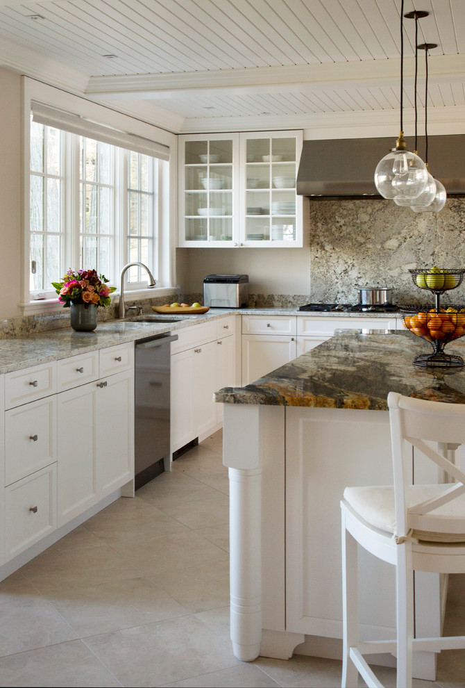 This is an example of a traditional l-shaped kitchen in Boston with white cabinets, stainless steel appliances, ceramic floors and with island.