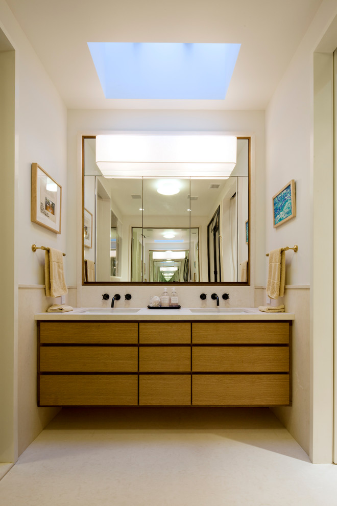 Large eclectic master bathroom in New York with flat-panel cabinets, medium wood cabinets, an alcove tub, an alcove shower, beige tile, ceramic tile, white walls, porcelain floors, beige floor and a hinged shower door.