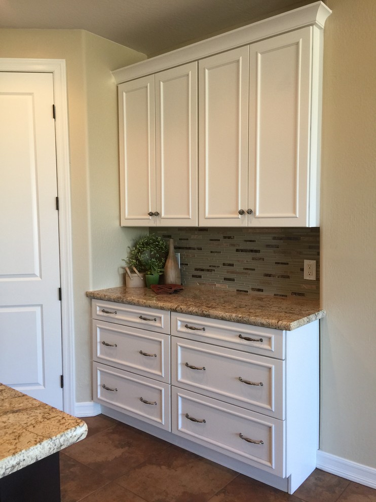 Inspiration for a large transitional eat-in kitchen remodel in Phoenix with granite countertops, gray backsplash, stone tile backsplash, black appliances and an island