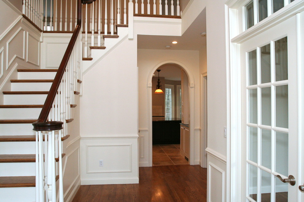 This is an example of a mid-sized transitional wood l-shaped staircase in Providence with wood risers.