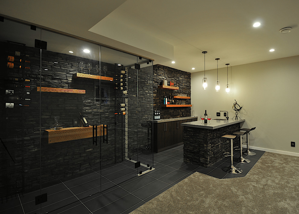 Design ideas for a mid-sized modern galley seated home bar in Calgary with an undermount sink, flat-panel cabinets, dark wood cabinets, concrete benchtops, multi-coloured splashback, stone tile splashback, porcelain floors and black floor.