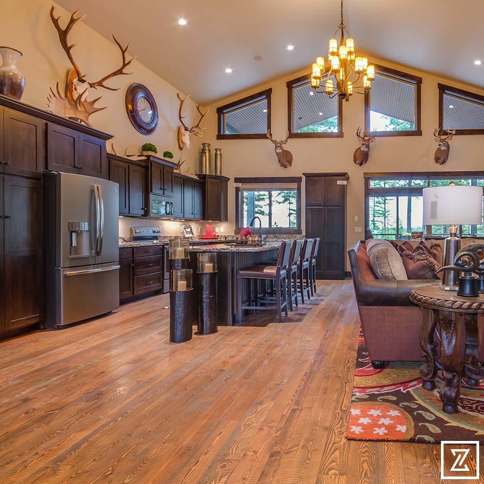 Country open concept family room in Other with beige walls, light hardwood floors, a wall-mounted tv and beige floor.