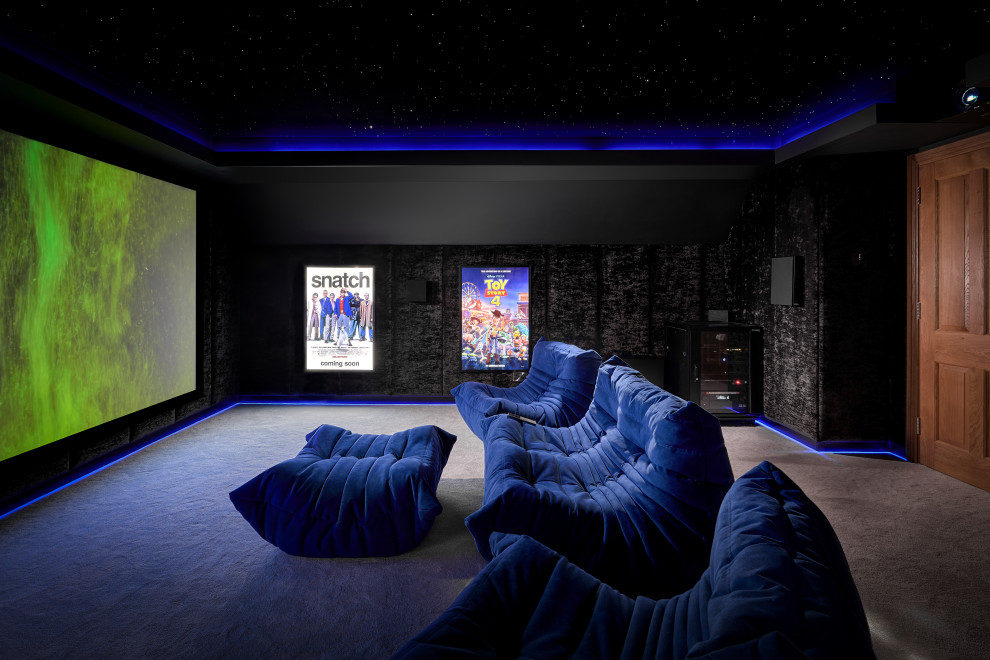 Small modern enclosed home cinema in Surrey with black walls, carpet, a projector screen, grey floors and feature lighting.