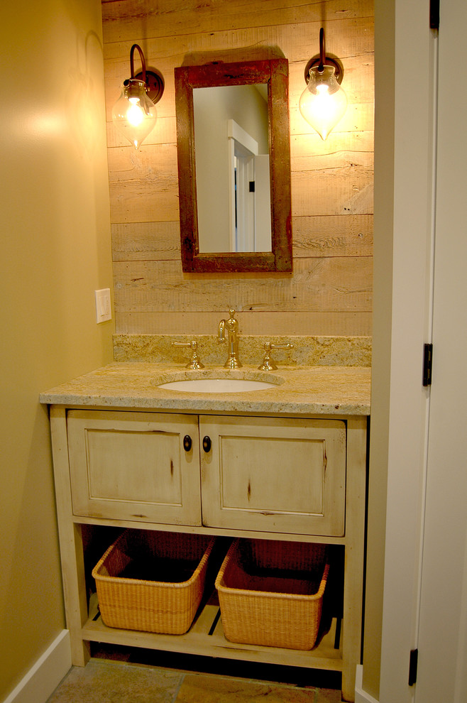 Small country powder room in Portland Maine with furniture-like cabinets, distressed cabinets, beige walls, slate floors, an undermount sink and granite benchtops.
