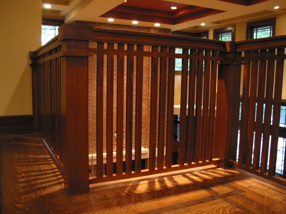 Photo of a large arts and crafts wood straight staircase in Chicago with wood risers.