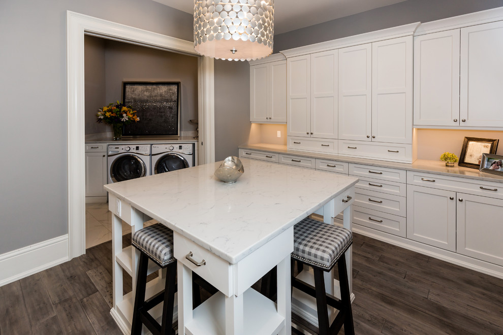 Example of a mid-sized transitional u-shaped painted wood floor eat-in kitchen design with a drop-in sink, recessed-panel cabinets, white cabinets, marble countertops, white backsplash, stainless steel appliances and an island