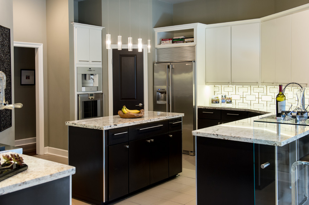 Mid-sized contemporary u-shaped eat-in kitchen in New Orleans with an integrated sink, flat-panel cabinets, white cabinets, granite benchtops, multi-coloured splashback, stainless steel appliances, limestone floors and with island.