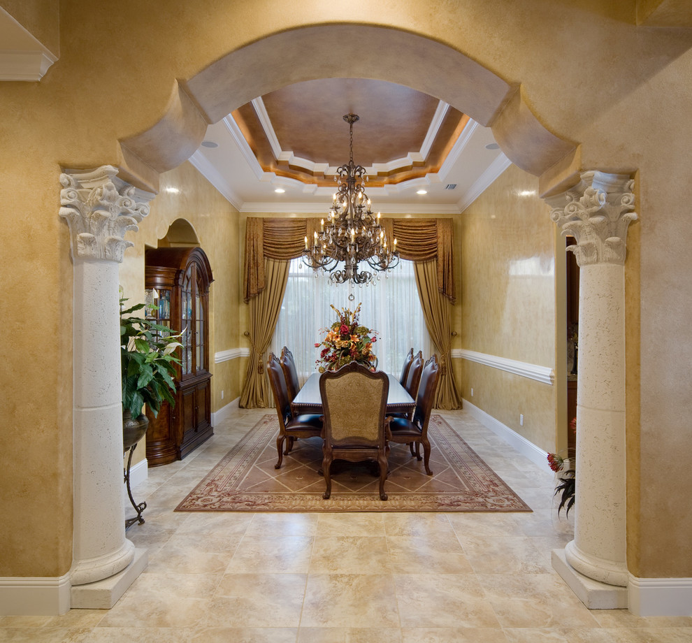 Example of a large tuscan enclosed dining room design in Orlando with beige walls
