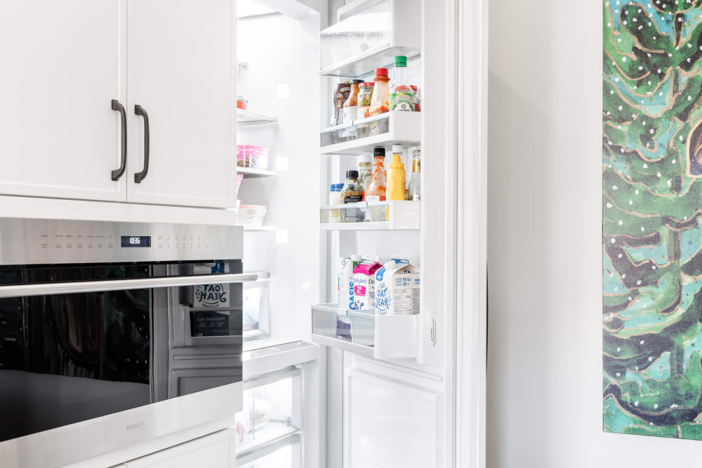 Example of a mid-sized transitional galley eat-in kitchen design with shaker cabinets and an island