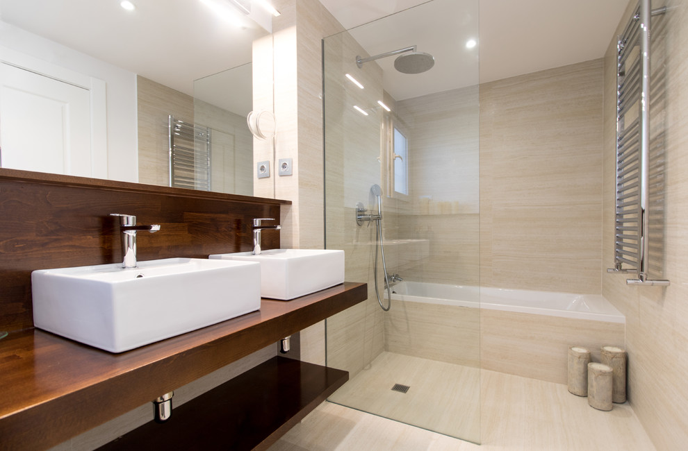 Design ideas for a mid-sized contemporary master wet room bathroom in Madrid with open cabinets, dark wood cabinets, an alcove tub, beige walls, a vessel sink, wood benchtops, beige floor, beige tile and an open shower.