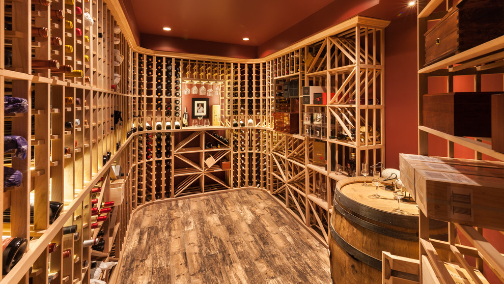 This is an example of a mid-sized country wine cellar in Other with porcelain floors and display racks.
