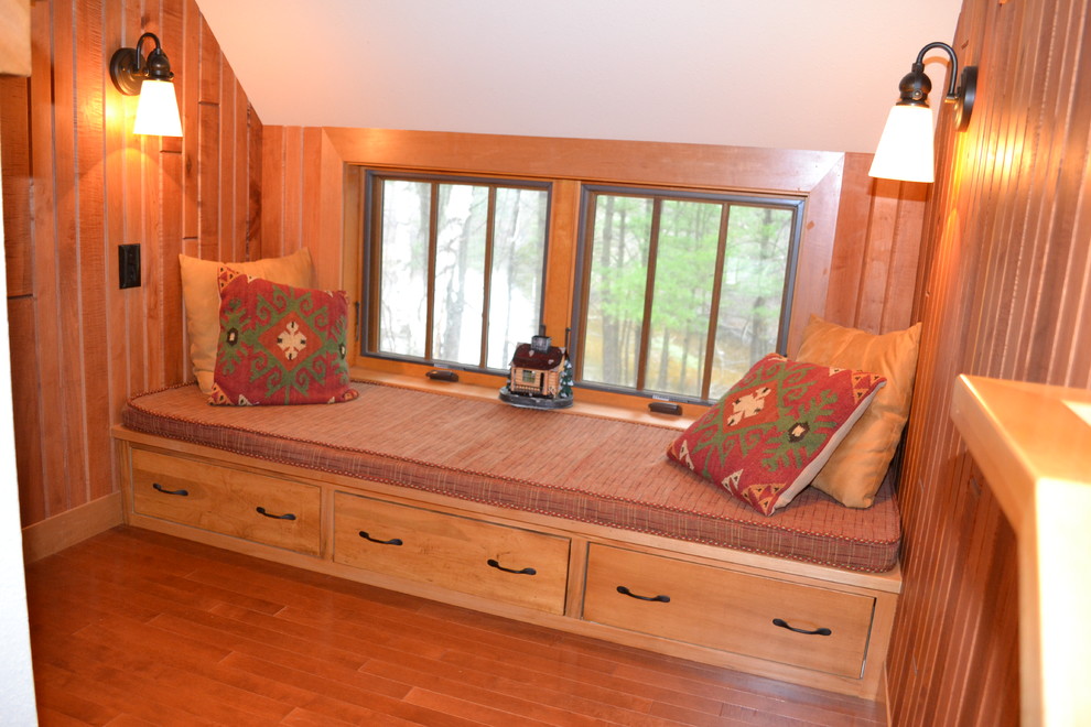 Example of a mid-sized mountain style light wood floor hallway design with white walls
