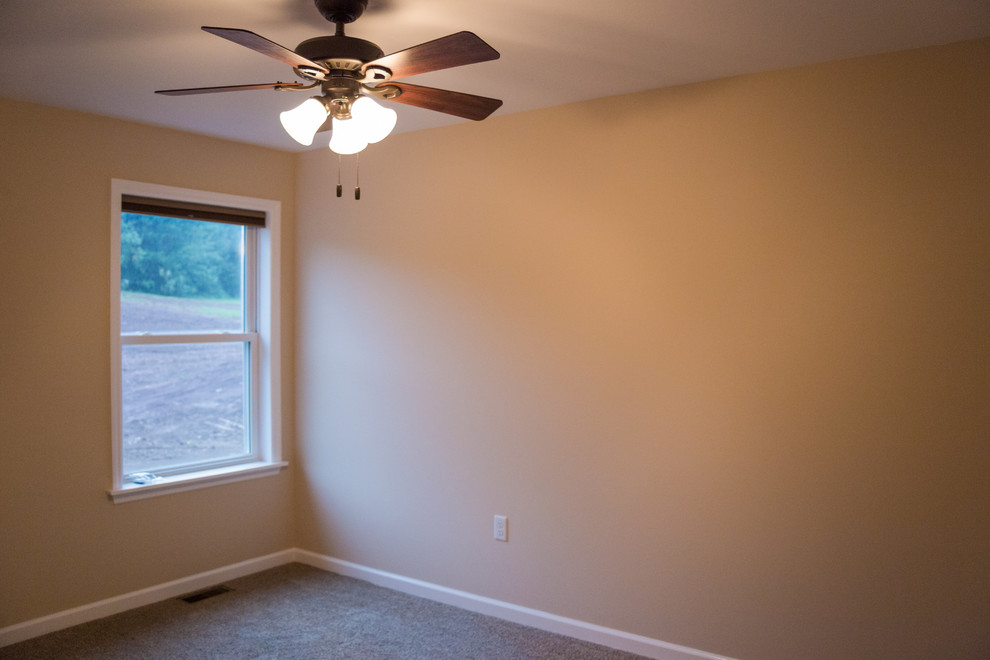 This is an example of a mid-sized contemporary guest bedroom in Other with beige walls, carpet and no fireplace.
