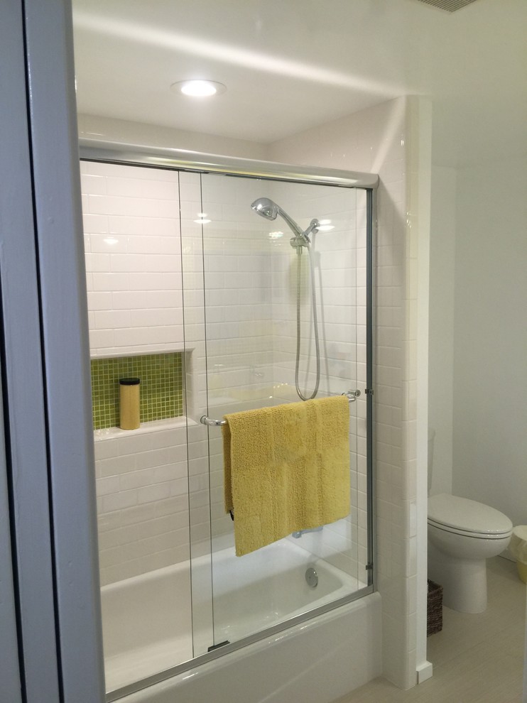Photo of a mid-sized midcentury bathroom in Other with white tile, white walls, flat-panel cabinets, dark wood cabinets, an alcove tub, a shower/bathtub combo, mosaic tile, porcelain floors, a drop-in sink, quartzite benchtops, grey floor and a sliding shower screen.