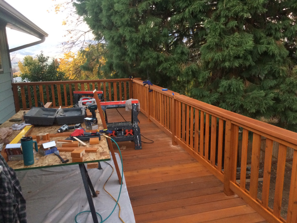 Inspiration for a small backyard second story wood railing deck remodel with no cover